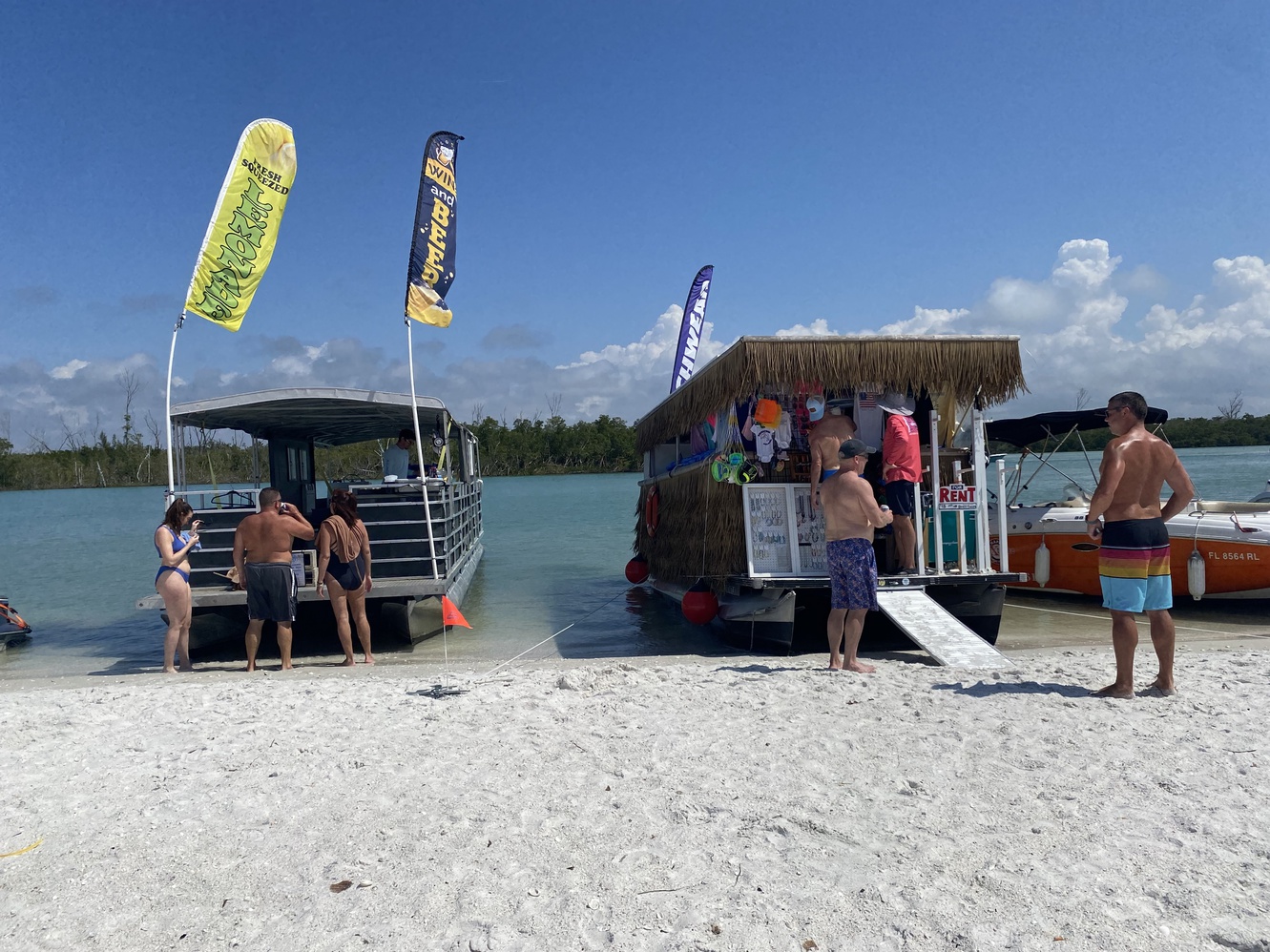 The Beer Boat has
      arrived, plus a floating shirt shack.